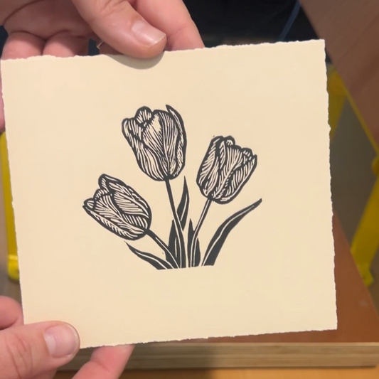 Handmade mini linocut print of three tulips in black ink on fawn tan paper, Mother's Day floral art